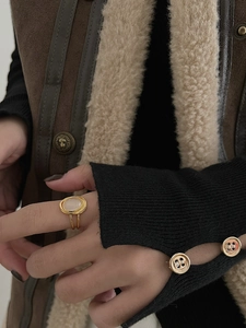 Detail of vintage gold layered ring with oval white agate stone worn on finger