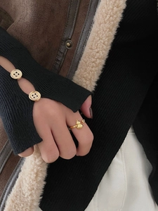 Macro detail of asymmetric gold-plated double gourd ring with sparkling zircon stones