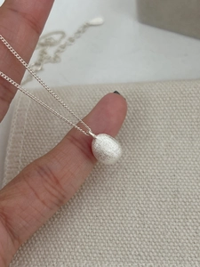 Detail shot of the matte brushed texture on the S925 silver teardrop pendant necklace