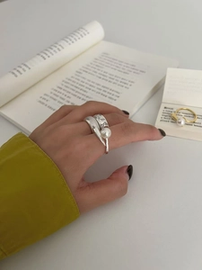 Detail of S925 sterling silver open rings with pearl and butterfly micro-inlay accents