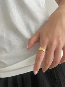 Macro view of wide 18K gold plated S925 silver ring with pavé zircon rectangle design