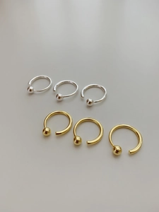 Detail view of gold and silver beaded open rings made of minimalist 925 sterling silver