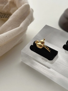 Macro detail of asymmetric 925 sterling silver gourd ring with gold polished finish