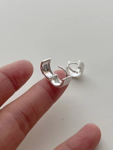 Macro shot of S925 sterling silver hoop earrings with brushed finish and hallmark