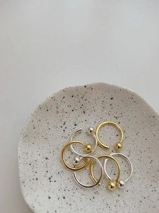 Detail of minimalist 925 sterling silver beaded rings in gold and silver finishes
