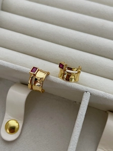 Close-up of golden hammered silver ring with rectangular pink cubic zirconia stone