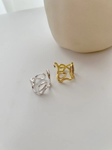 Detailed view of minimalist irregular S925 silver wave rings in gold and silver finishes