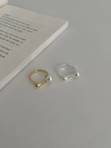 Detail of elegant S925 sterling silver pearl open rings in gold and silver finish