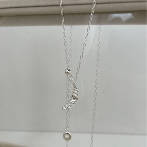 Minimalist sterling silver croissant pendant necklace on a delicate fine link chain