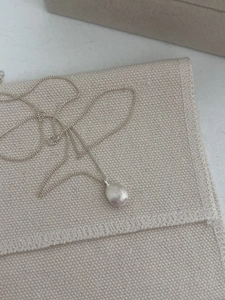 Macro detail of the matte brushed texture on the S925 sterling silver oval pendant