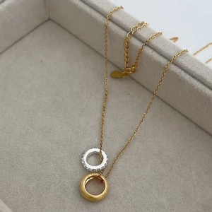 Two-tone intertwined double ring pendant necklace with crystals and brushed finish