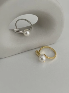 Minimalist S925 silver and gold open rings featuring single pearls on a stone backdrop