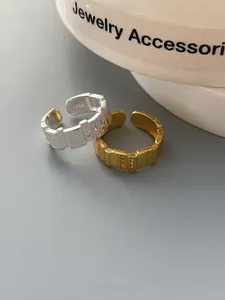 Detailed view of adjustable S925 sterling silver rings with zircons and gold plating