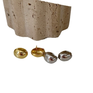 Minimalist bean-shaped metal stud earrings in gold and silver with polished mirror finish