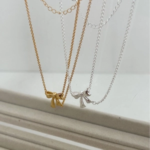 Minimalist sterling silver ribbon bow necklaces in elegant gold and silver finishes