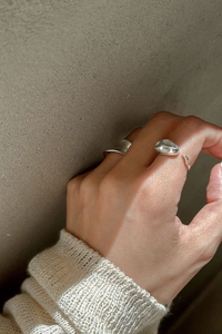 Close-up of S925 sterling silver rings with irregular geometric textures and organic shapes