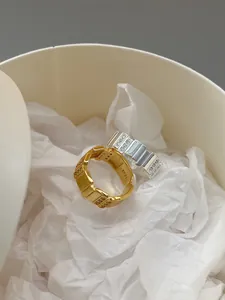 Detailed view of S925 sterling silver geometric rings with zircons in a gift box