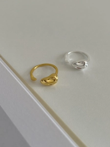 Detail of gold and silver irregular lava rings with high polished mirror finish