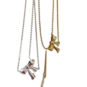Minimalist sterling silver bow pendant necklace in gold and silver finishes