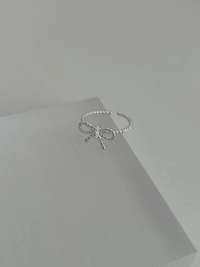 Detail of S925 sterling silver bow ring featuring a beaded textured twist design
