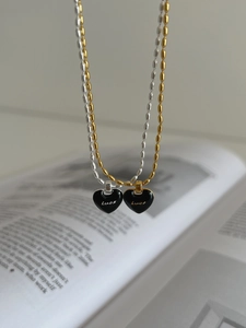Detail of s925 silver heart necklaces with black enamel Lucky pendant on bead chain