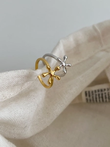 Detail view of gold and silver S925 sterling silver rings with artistic radial branch design