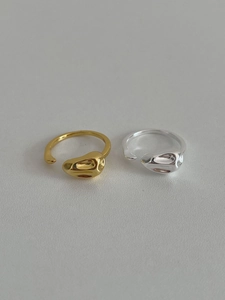 Close-up of gold and silver irregular organic rings with molten liquid metal texture