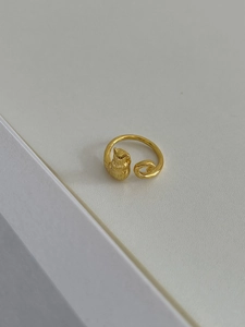 Macro detail of gold-plated cat-shaped adjustable ring showing delicate craftsmanship