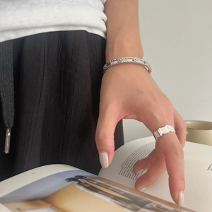 Elegant 925 sterling silver zircon clover bracelet and quilted ring on a female model