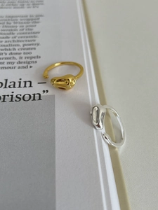 Detail shot of molten-style S925 sterling silver rings in gold and silver finishes