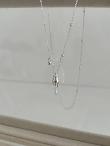 Detailed view of 925 sterling silver hand-shaped pendant with pavé set zirconia stones