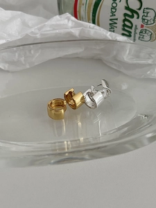 Detailed macro shot of S925 sterling silver star hoop earrings in gold and silver finish