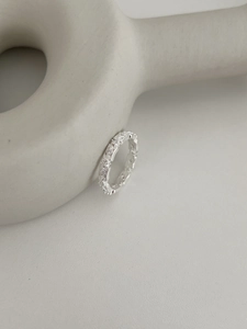 Close-up of vintage hollow lace silver ring with pavé diamonds and beaded edges