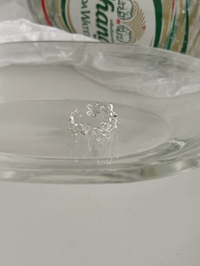 Detailed close-up of S925 sterling silver hollow flower ring with adjustable band design