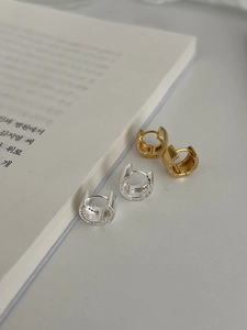 Detailed close-up of gold and silver S925 sterling silver hoop earrings with zircon stars