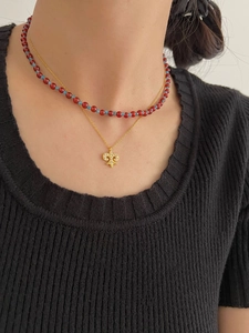 Close-up of layered S925 silver iris flower pendant necklace and colorful beaded chain