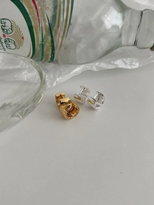 Close-up of gold and silver S925 sterling silver hoop earrings with small zircon stars