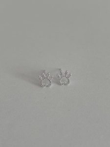Macro detail of S925 silver cat paw stud earrings with shimmering zircon pavé stones
