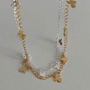 925 silver cross pendant necklaces in gold and silver finish on textured background