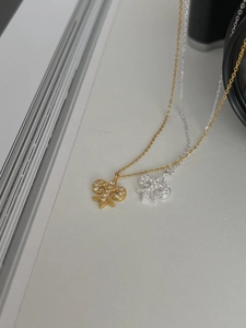 Macro shot of S925 sterling silver fleur-de-lis pendants with sparkling zircon inlay