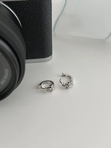 Macro shot of 925 sterling silver hoop earrings with vintage gothic floral engravings