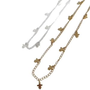 Cross charm necklace set in gold and silver finish with detailed sunburst engraving