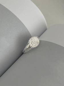 Macro detail of S925 sterling silver ring with sunburst flower pattern engraving