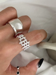 Détail d'un ensemble de bagues en argent S925 avec anneaux minimalistes, grillagés et gemme