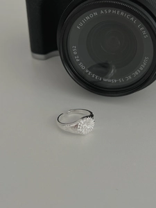 Macro shot of S925 sterling silver sunburst signet ring with adjustable open band detail