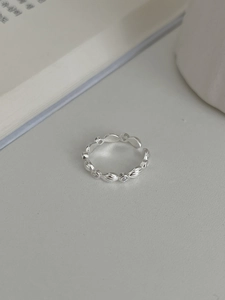 Macro shot of silver-colored wavy adjustable ring featuring tiny inlaid cubic zirconia