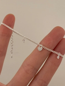 Close-up of S925 sterling silver water drop necklace with heart pendant and tassels