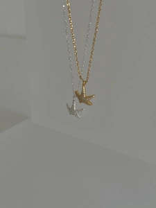 Close-up of gold and silver 925 sterling silver starfish necklaces with micro pavé crystals