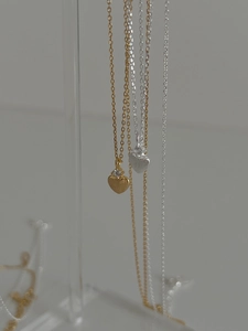 Détail macro du pendentif cœur en argent 925 avec finition dorée et zircon