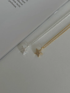 Detailed close-up of 925 sterling silver star necklaces with sparkling zircon inlay